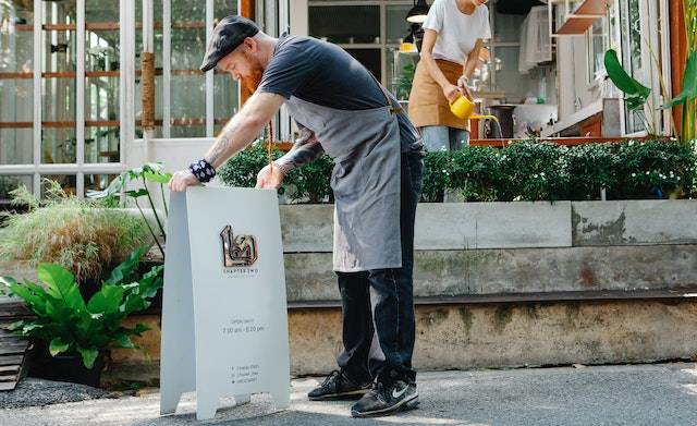 restaurant owner setting up sign